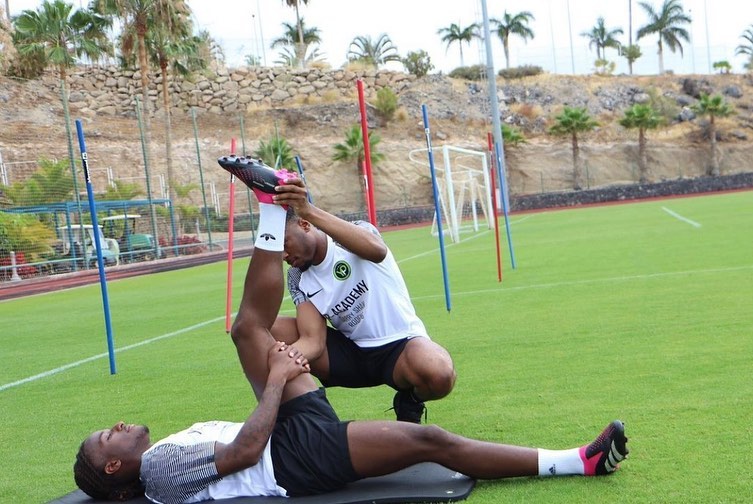 Dom giving an assisted hamstring stretch on the pitch